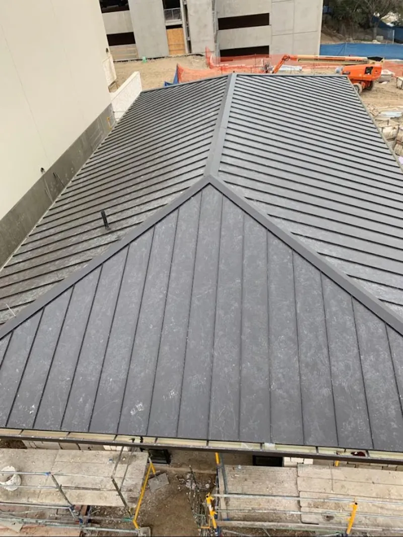 Commercial metal roof construction with crane equipment in Wauseon