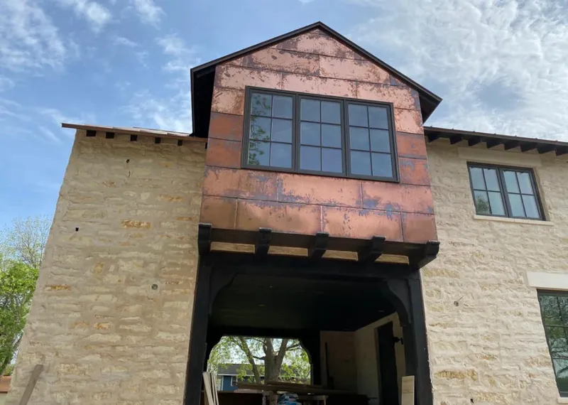 Copper metal panel facade on a stone building for Roof Repair in Wauseon